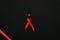 Infection symbol. Red ribbon symbol in hiv world day on dark background. Awareness aids and cancer. Healthcare and