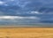 Infinite horizon with stormy clouds and endless beach