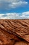 Infinite rock folds under the bright sky with clouds, The Chains, Page, Arizona, USA