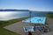 Infinity outdoor pool overlooking fjord mountains in Hofsos in northern Iceland