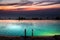 Infinity pool above seaside at dusk