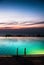 Infinity pool above seaside at dusk