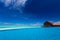 Infinity pool over tropical lagoon with blue sky