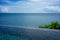 Infinity pool with plant vegetation and wide ocean view