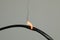 Inflamed black wire on grey background, closeup. Electrical short circuit