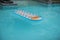 Inflatable blue and orange Mattress in Swimming Pool