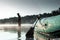 Inflatable boat on the lake at dawn, a fisherman at dawn fishing. Fishing hobby vacation concept. Copy space