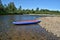 Inflatable boat on the pebbly Bank of the river.