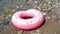 Inflatable colorful Rubber Ring floating on the seashore