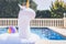 Inflatable colorful white unicorn at the swim pool. Holidays week in the swimming pool with plastic toys. Relaxation and