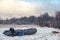 Inflatable fishing boat on the bank of a winter river