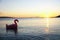 Inflatable flamingo silhouette on sea surface at beautiful sunset