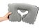Inflatable grey travel pillow with hand isolated on white background.