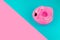 Inflatable mini flamingo on pastel blue and pink background. Pool float party, trendy summer concept. Flat lay, copy space.