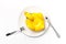 Inflatable mini yellow chicken or duckling on white plate, fork knife on white background. Creative food concept, tobacco chicken