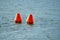 Inflatable orange buoys in a lake