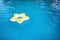 Inflatable ring floating in swimming pool