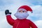 inflatable santa claus in front of blue sky