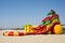 Inflatable slide on the sea, sea shore. Inflatable hill. Rubber inflatable hill on the lake shore against the blue sky