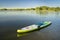 Inflatable stand up paddleboard floating on lake