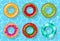 Inflatable swimming rings set looking like orange, watermelon, kiwi, donut, strawberry and tropical on water pool