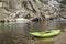 Inflatable whitewater kayak on a rocky shore of a mountain river