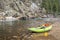 Inflatable whitewater kayak on a rocky shore of a mountain river
