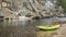 Inflatable whitewater kayak on a rocky shore of a mountain river