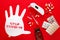 Inflated medical glove with stop covid-19 text message, syringe, pills and thermometer on red background