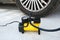 Inflating a flat tire, wheel with an electric pump on a road, maintenance and car service