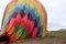 Inflation process and preparation of hot air balloon at sunrise to fly in cloudy sky