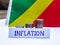 Inflation in Republic of the Congo concept. Handwritten Inflation on a paper board, growing up arrow, coins and flag of Republic