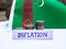 Inflation in Turkmenistan concept. Handwritten Inflation on a paper board, growing up arrow, coins and flag of Turkmenistan in the