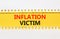 Inflation victim symbol. Concept words Inflation victim on yellow paper. Beautiful yellow table white background. Business