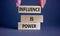 Influence is power symbol. Wooden blocks with words `Influence is power`. Beautiful grey background, businessman hand. Business,