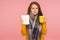 Influenza treatment. Portrait of unhealthy ginger girl wearing big scarf, holding napkin and cup with hot tea, treating flu