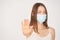 Influenza virus stop gesture. Girl in face mask deny sign. selective focus