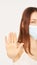Influenza virus stop gesture. Girl in face mask show deny sign. selective focus.