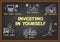 Info graphics on chalkboard about investing in yourself.