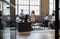 Informal business meeting seen through open glass doors