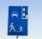 Information road sign, blue rectangular shield with human figures, car and parking marking. Attention, pedestrian zone