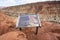 Information sign for the Goosenecks Point area in the Captiol Reef National Park on a cloudy spring day