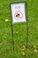 An information sign in a park intended for a picnic in Prague, Czech Republic, with the words ` Boots in the hand, feet in the gra