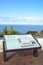 Information sign in Pico das Camarinhas viewpoint, Ponta Ferraria, Azores islands, Portugal. Blue Atlantic ocean and