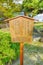 Information wooden signboard depicting history of the Japanese Kyu-Shiba-Rikyu garden.