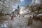 Infrared landscape of old church in churchyard in English countr