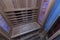 Infrared sauna interior close up view. Wooden walls and bench, ceramic heaters.