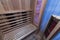 Infrared sauna interior close up view. Wooden walls and bench, ceramic heaters.