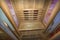 Infrared sauna interior close up view. Wooden walls and bench, ceramic heaters.