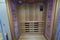 Infrared sauna interior close up view. Wooden walls and bench, ceramic heaters. Healthy lifestyle concept